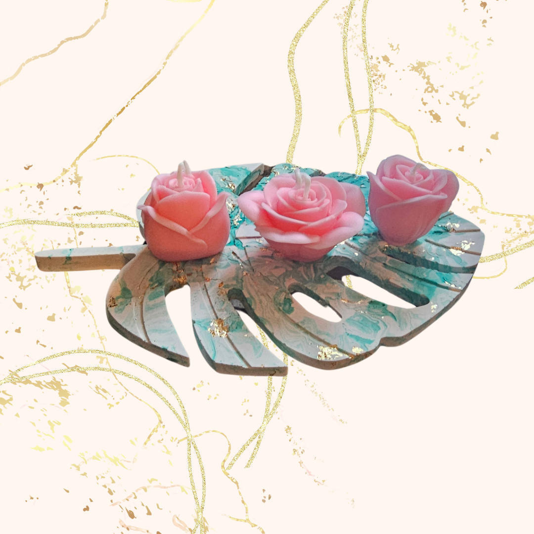 3 scented rose candles on a tray.