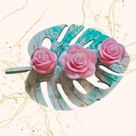 3 scented rose candles on a tray.
